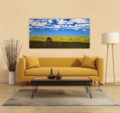 Bumper Crop and original oil painting of a hay bale and canola field hanging on a yellow wall in a living living room over a yellow couch