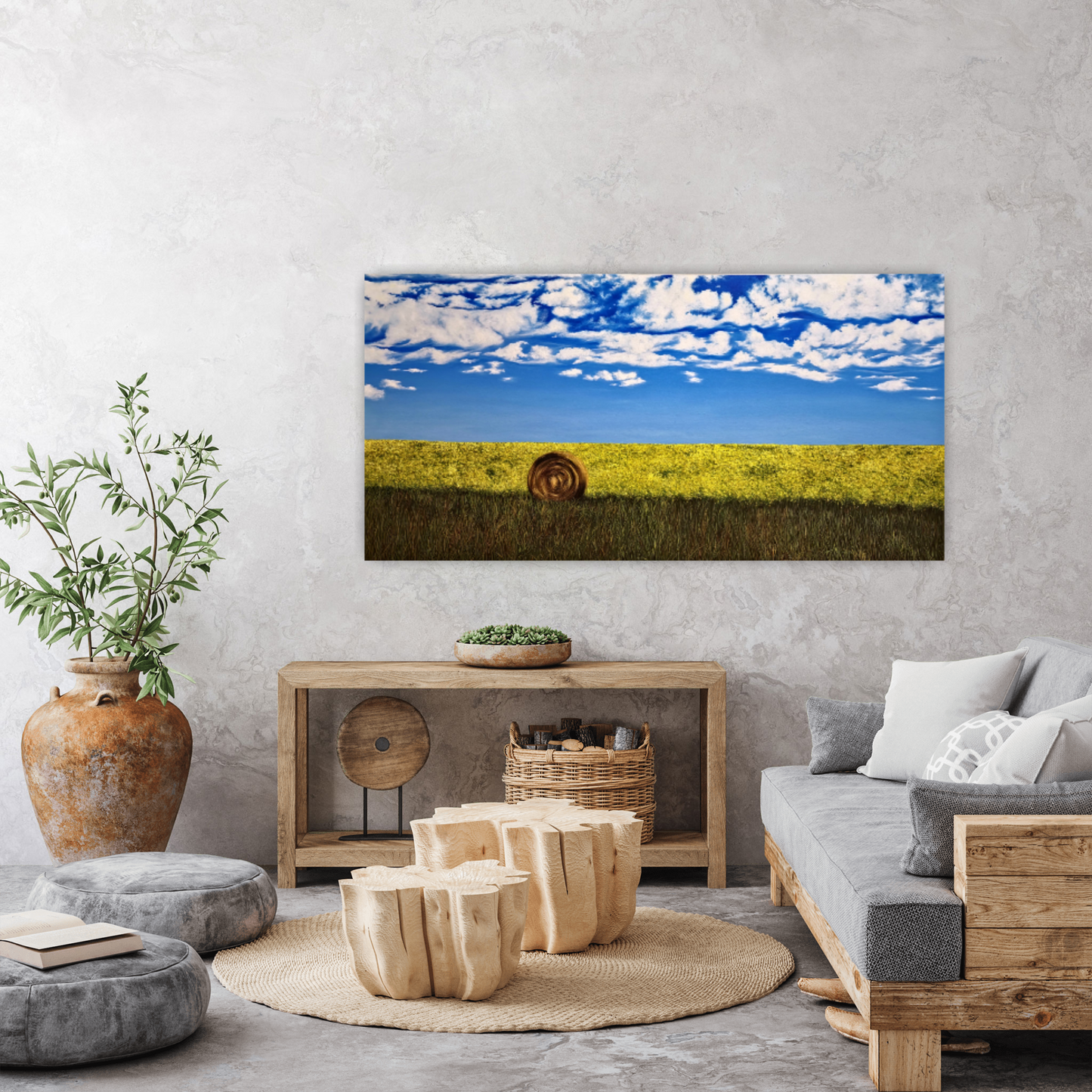 Bumper Crop and original oil painting of a hay bale and canola field hanging on the wall in a living rustic living room