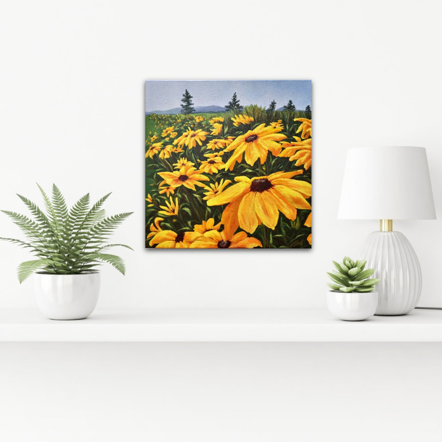 Christina Gouldsborough's original oil painting of brown eyed susans in a row leading off into the distance on a white wall behind a shelf with plants and a lamp