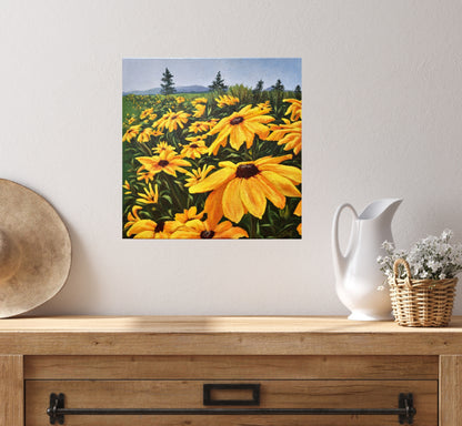 Christina Gouldsborough's original oil painting of brown eyed susans in a row leading off into the distance on a wall behind a wood dresser