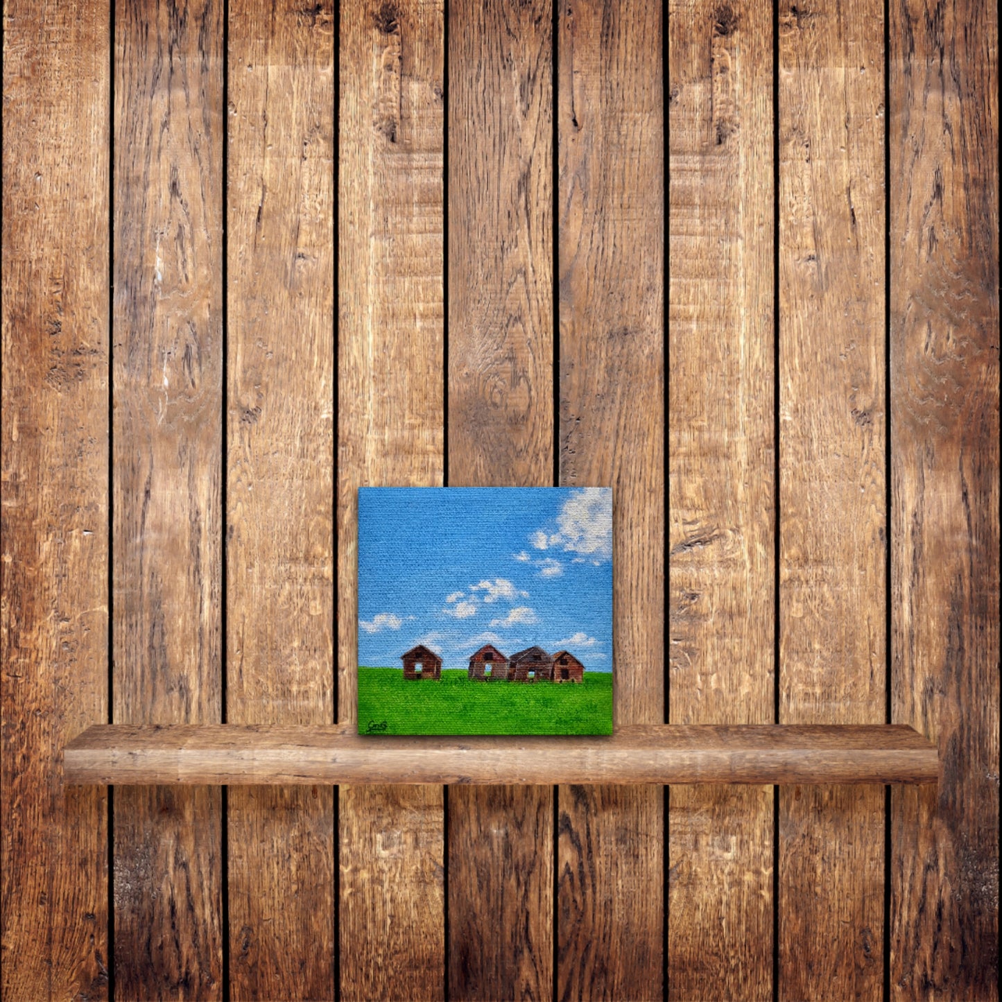 Small original oil painting of 4 vintage sheds in a green field in summer, on a pine wood wall on a wood shelf