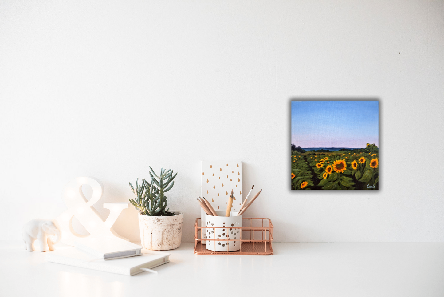 painting of august sunflowers over a desk with some stationary