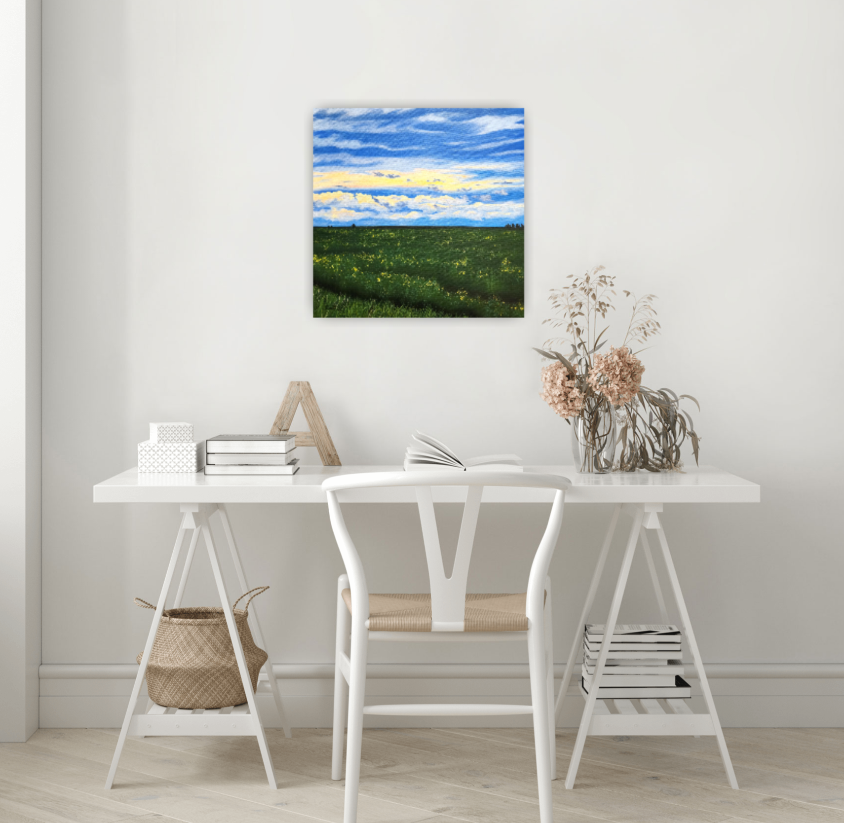 After the Rain Canadian landscape painting of a summer canola field after a rain storm by Christina Gouldsborough on a wall behind a white desk