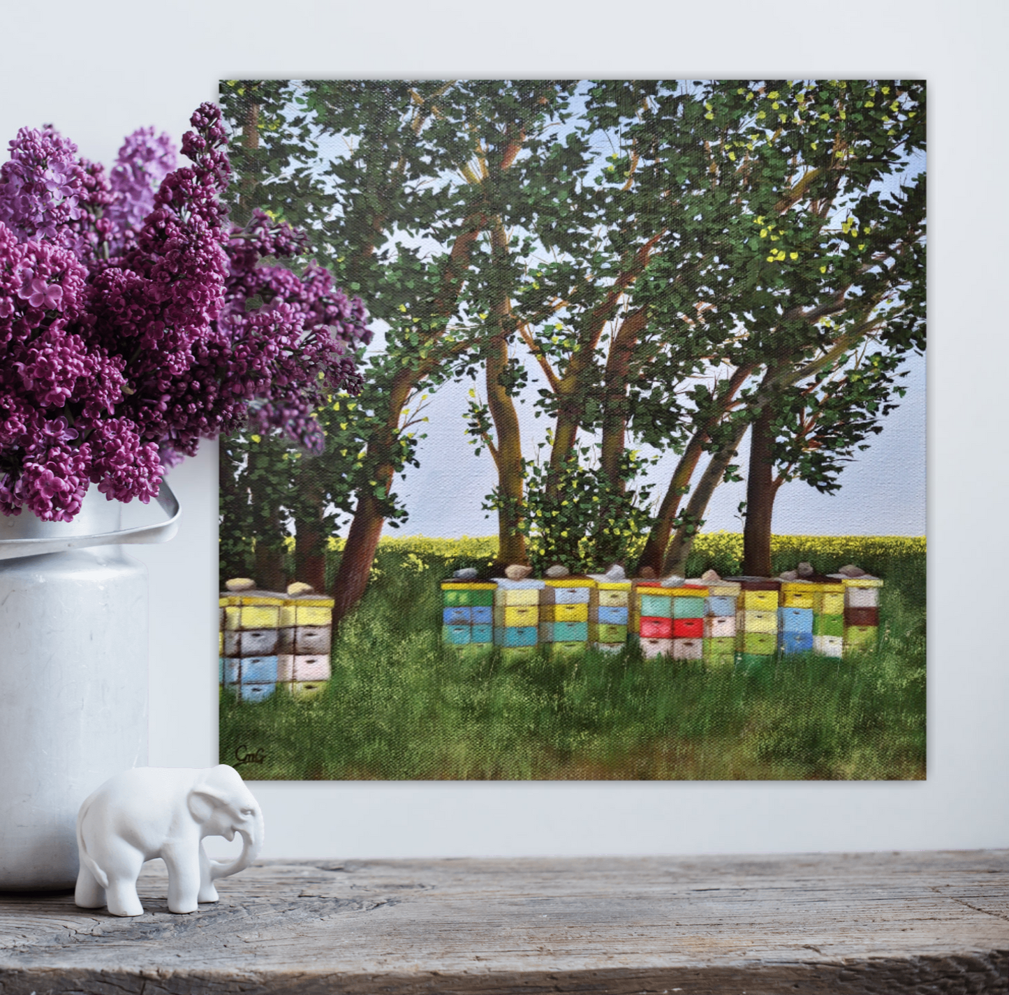 Life is Sweet - an original landscape painting of bee boxes under swaying willows in an open field By Christina Gouldsborough - painting on wall behind flowers